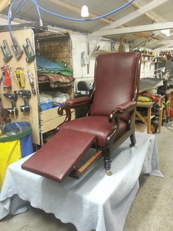 Brown leather chair with foot rest