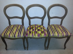 The dining chairs with green and purple paneling